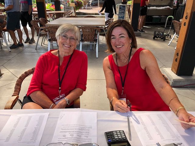 Eileen and Lori checking times and scores